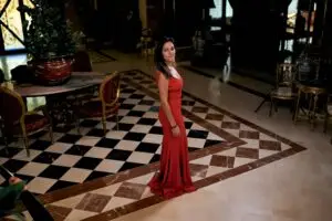 young brunette woman with a red dress in the living room