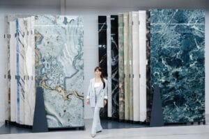Woman choosing marble tile samples in showroom